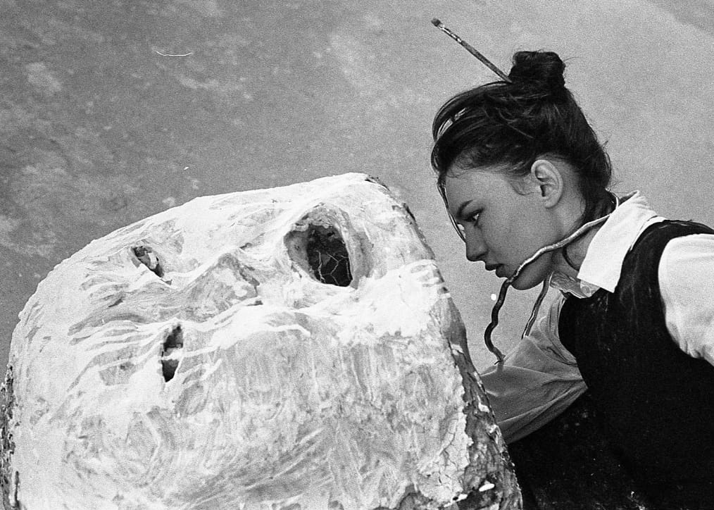 A person looking at a sculpture