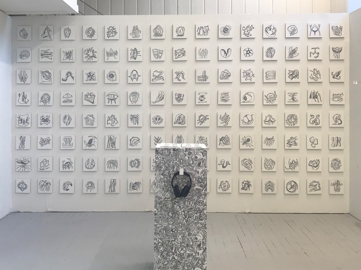 'Aftoglyphs', 2025, installation, acrylic and ink on wood, 121 x 17cm x 17cm, digital fabric print, 200cm x 110cm, ink on canvas, 11 x 30cm x 30cm, audio, 7 minutes 34 seconds duration