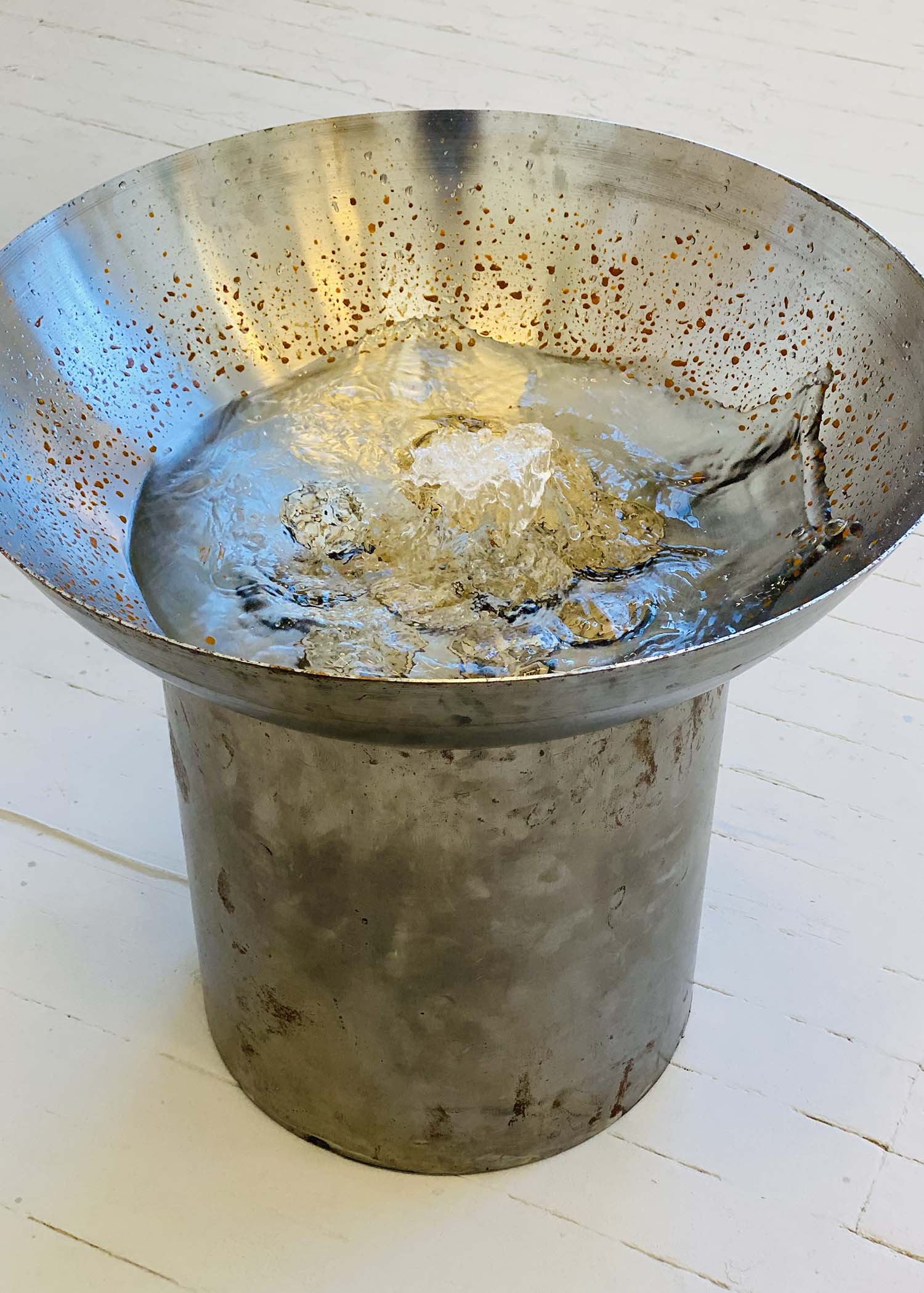 Steel fountain containing bronze coins