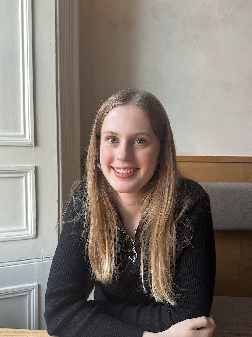Photograph of Katie smiling in a black shirt