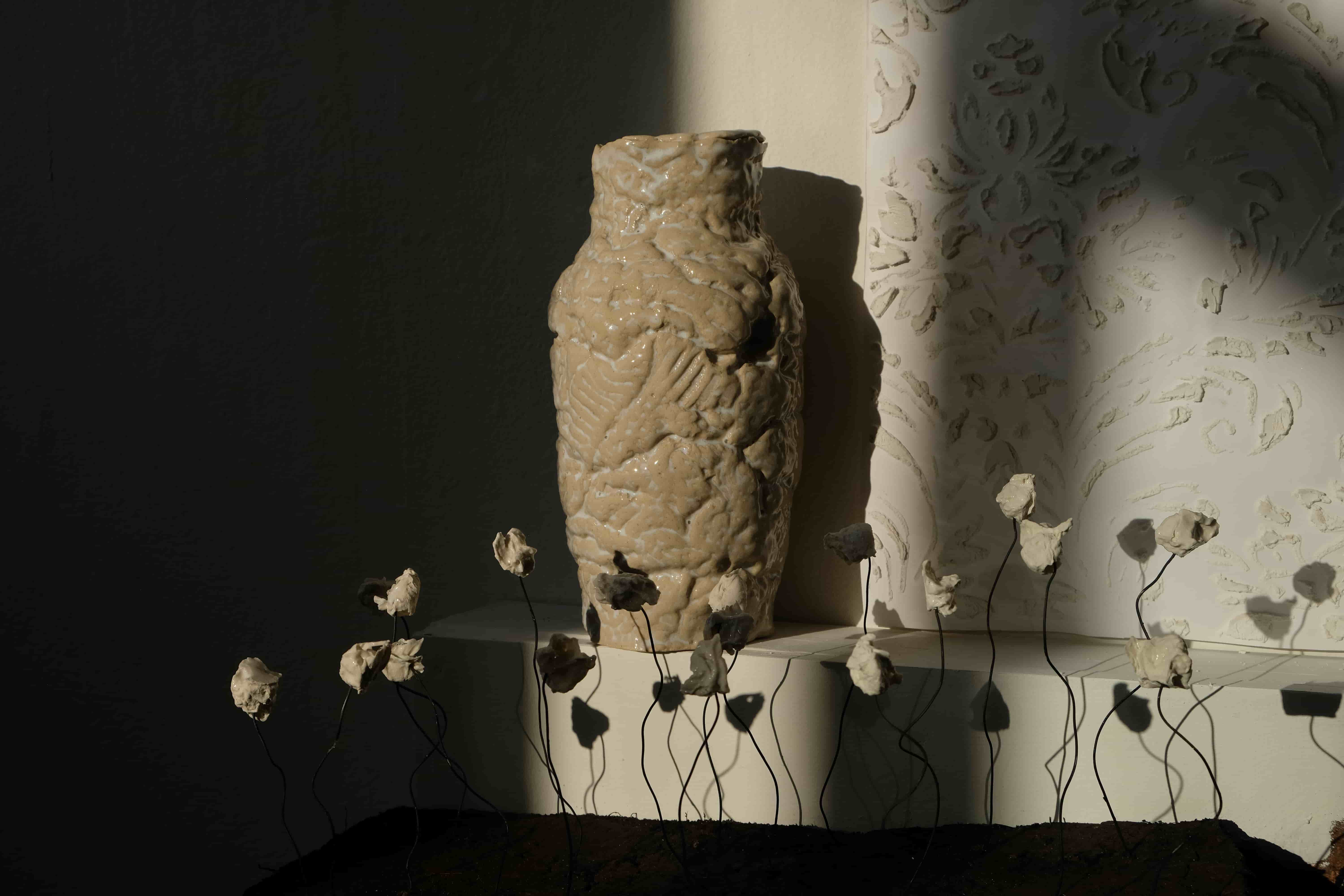 Ceramic vase and wallpaper in background