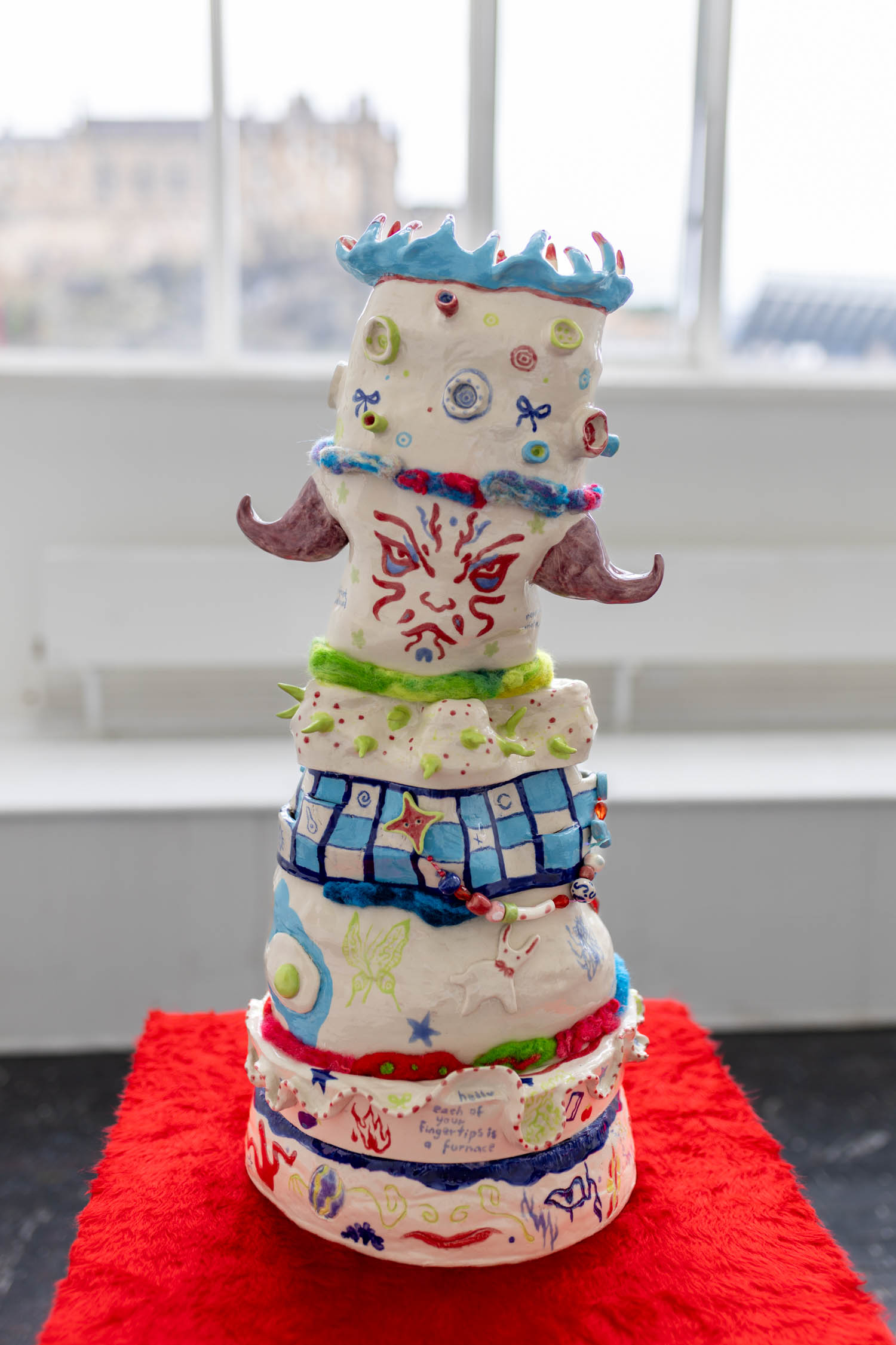Back side of ceramic tower, with Edinburgh Castle visible through the window.