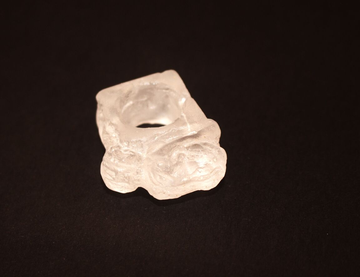 glass ring of a woman laying down. 