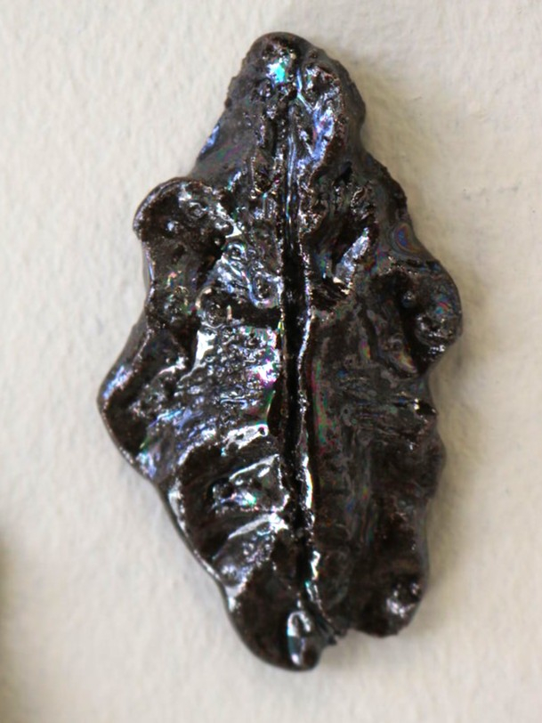 Vulva sculpture in dark opal lustre.