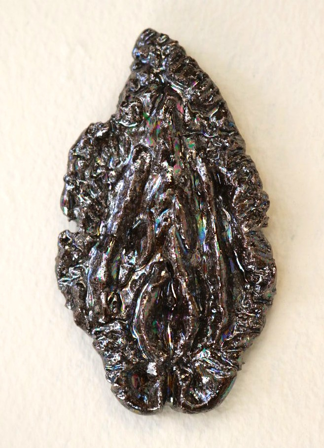 Vulva sculpture in dark opal lustre.