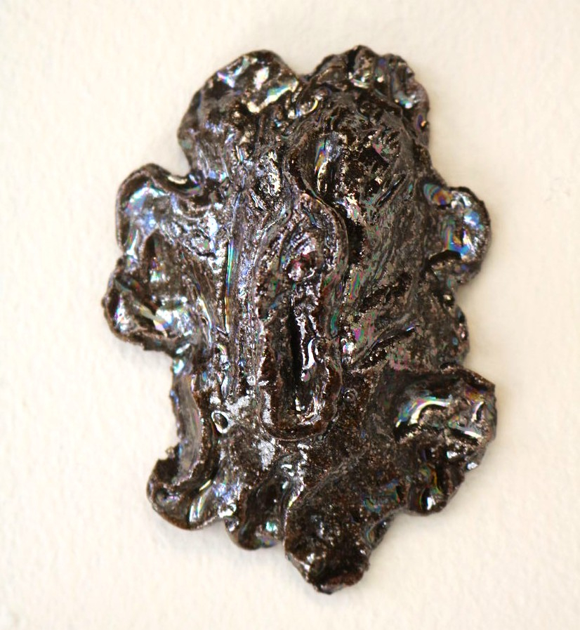 Vulva sculpture in dark opal lustre.