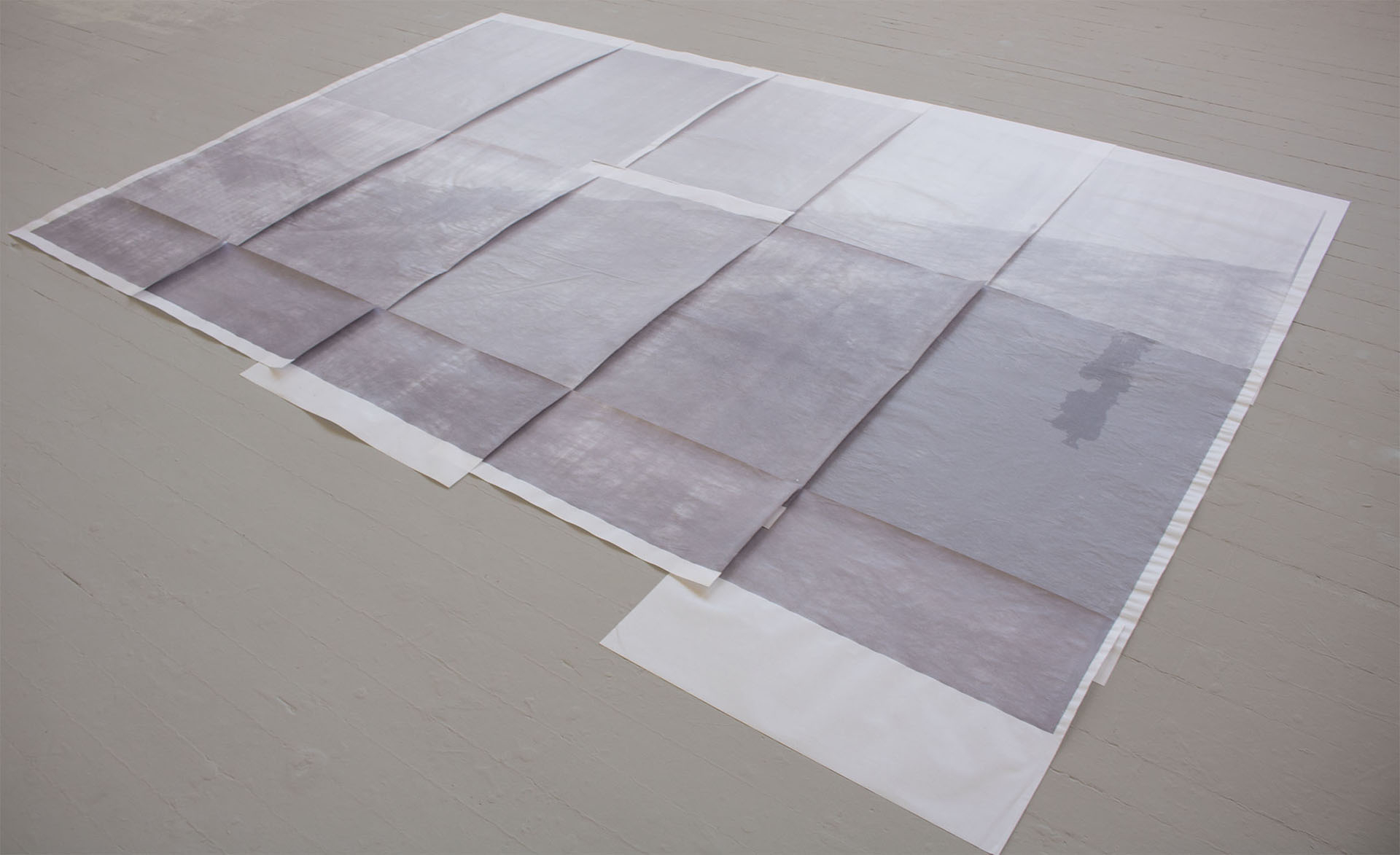 Artwork displayed on the floor of a landscape