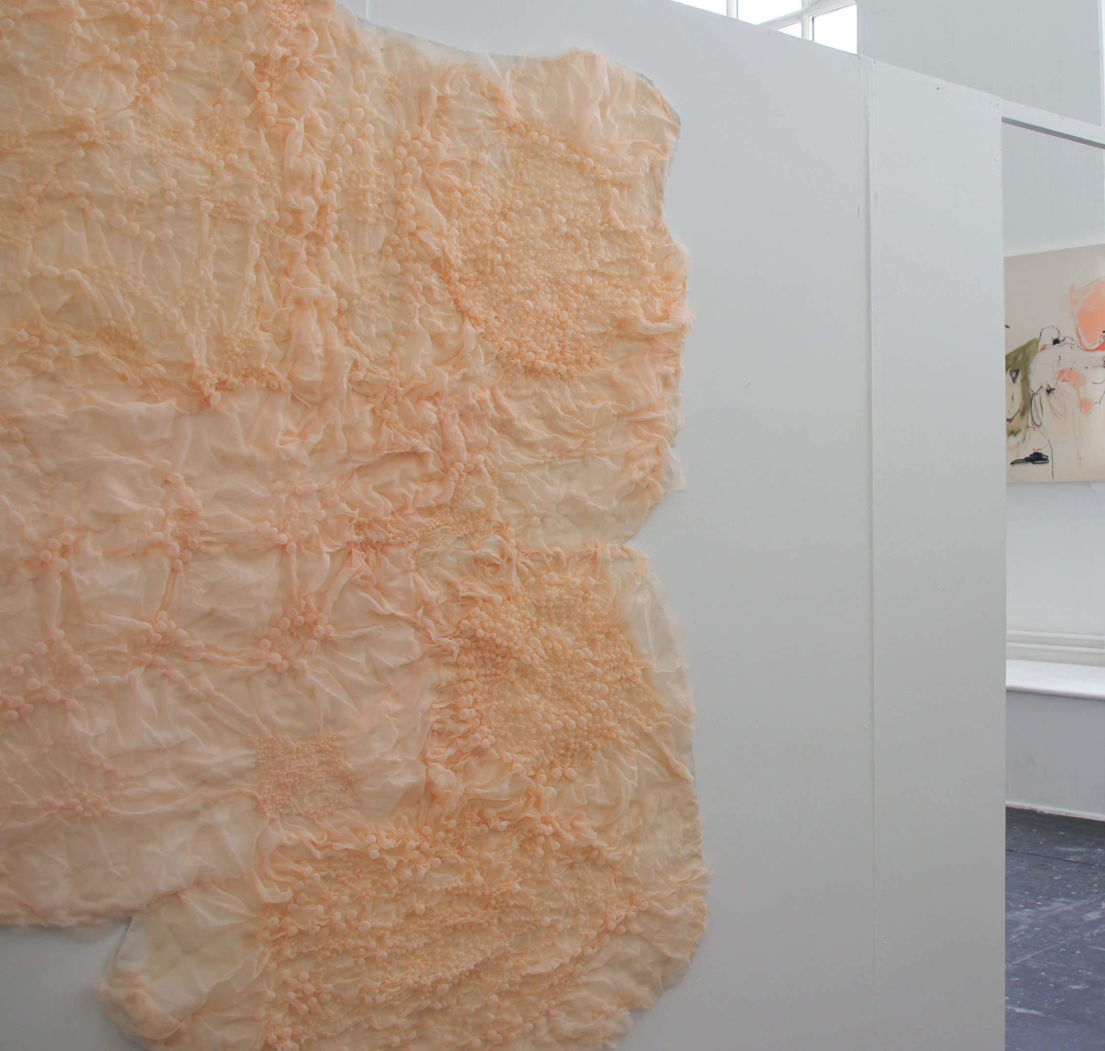 the right edge of a pink, bubble textured fabric with a complex pattern, next Tao painting with a pool of similar pink colour