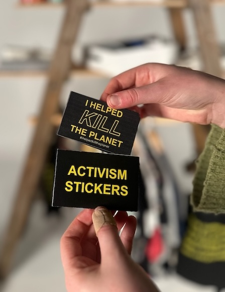 Sticker pack in front of The Museum of Overconsumption