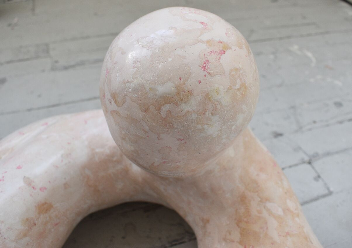 Closeup of a big Clitoris Sculpture in Scagliola pink and white marble reproduction.