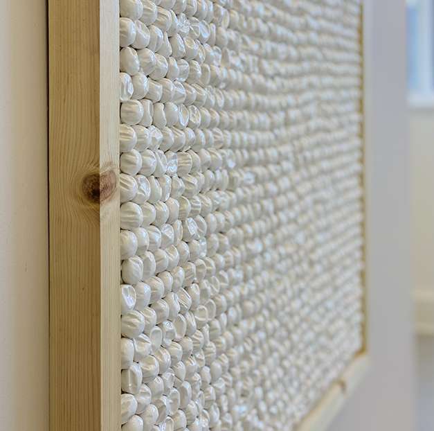 Ceramic bubbles on canvas seen from an angle