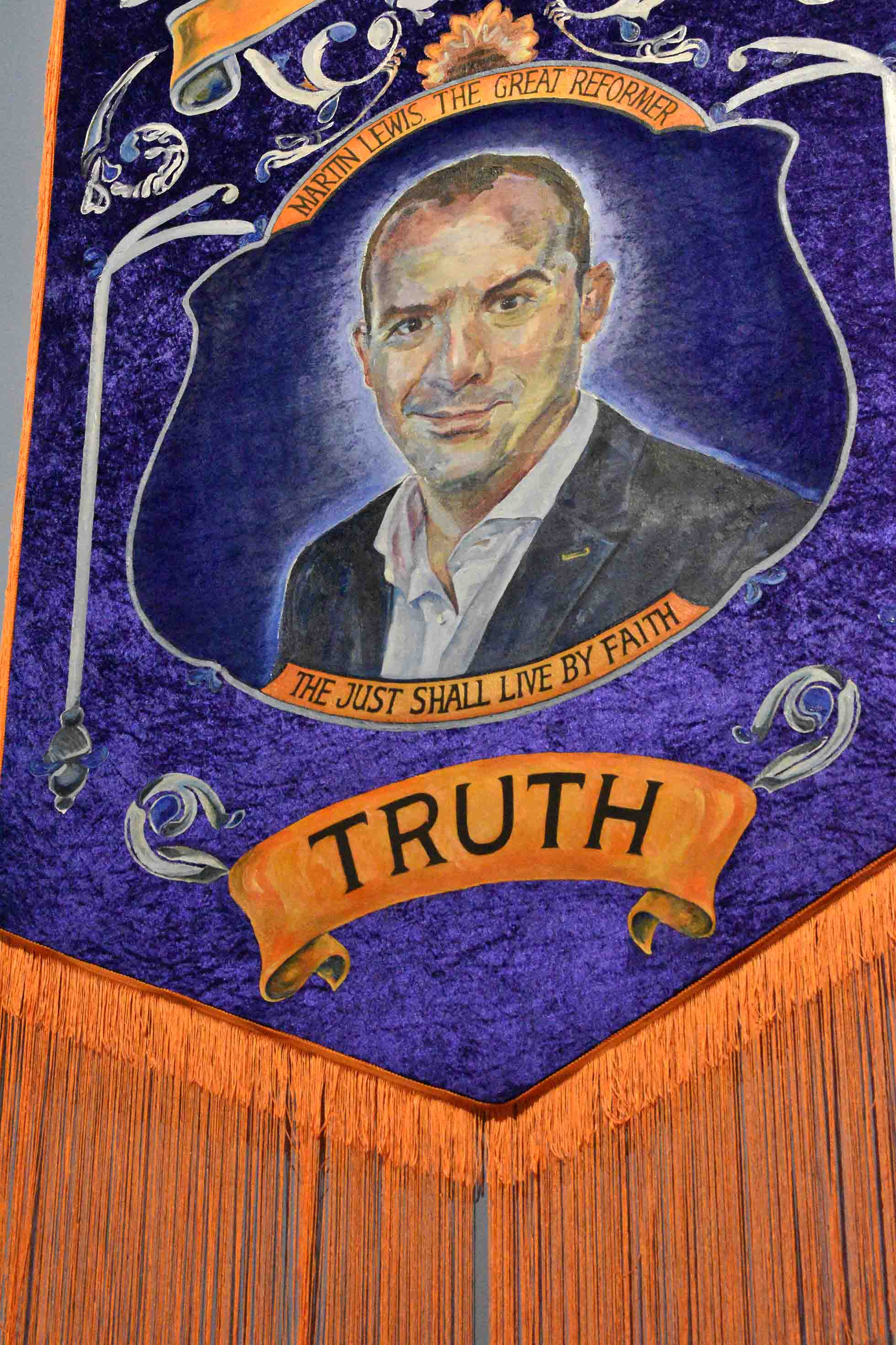 Martin Lewis in place of Martin Luther on a crushed velvet purple Orange Lodge banner. Text reads 'MARTIN LEWIS THE GREAT REFORMER, THE JUST SHALL LIVE BY FAITH' 