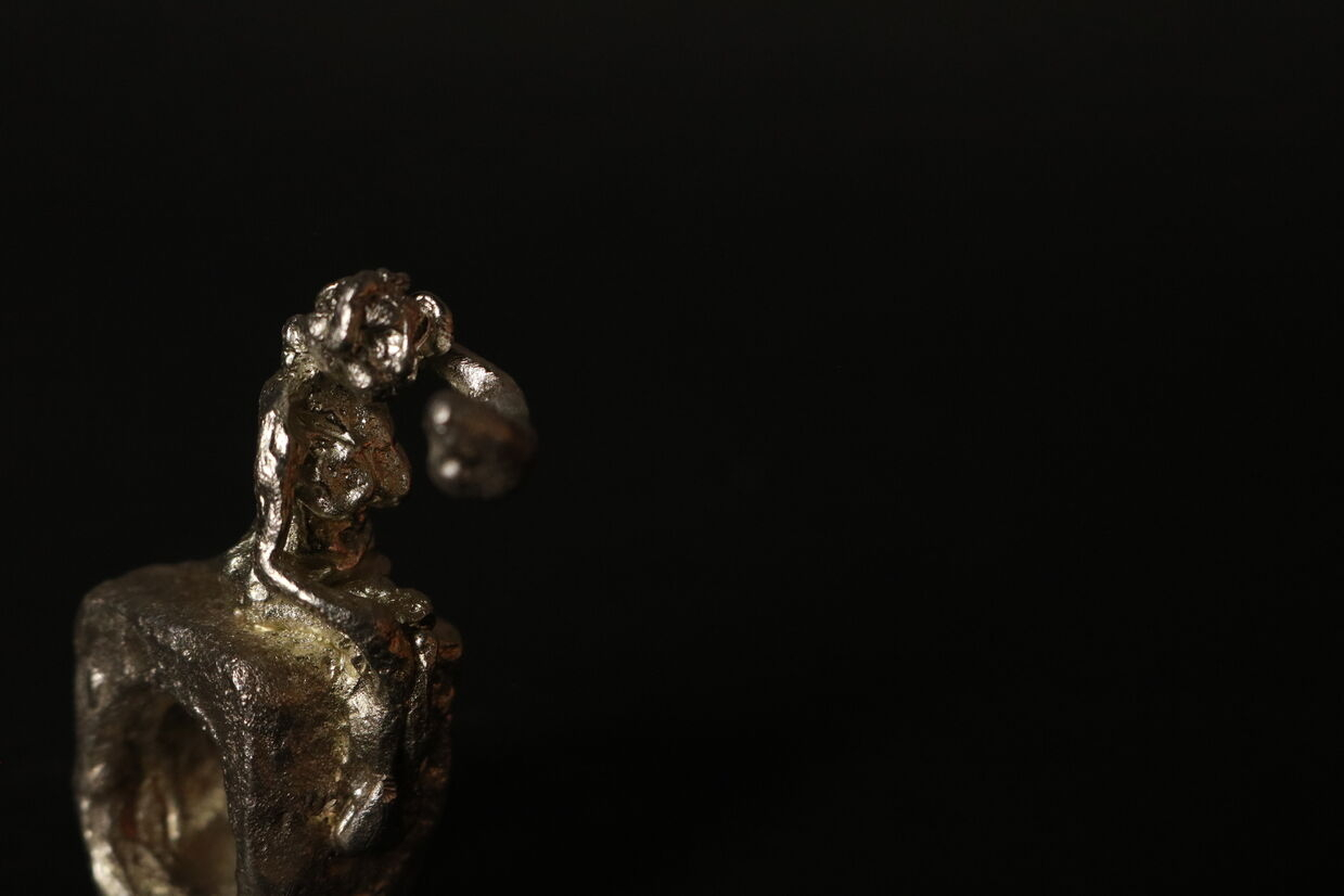 Pewter ring of a woman reaching out. 