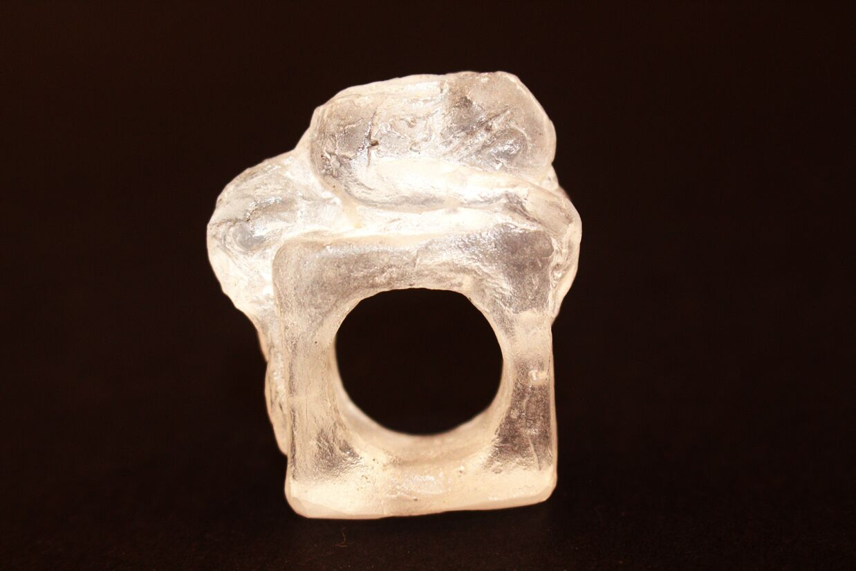 glass ring of a woman laying down. 