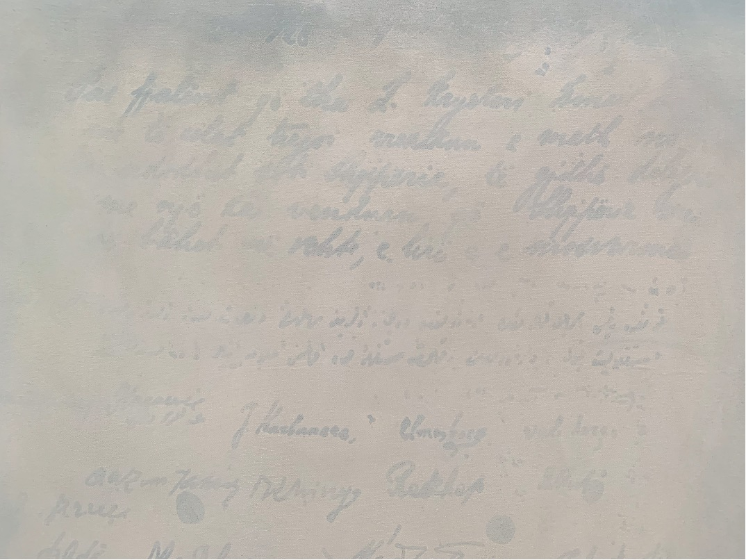 Close-up shot of painting depicting faded writing.