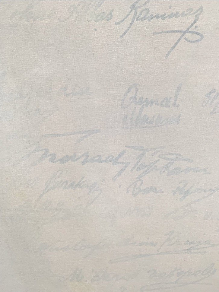 Close-up shot of painting depicting faded writing.