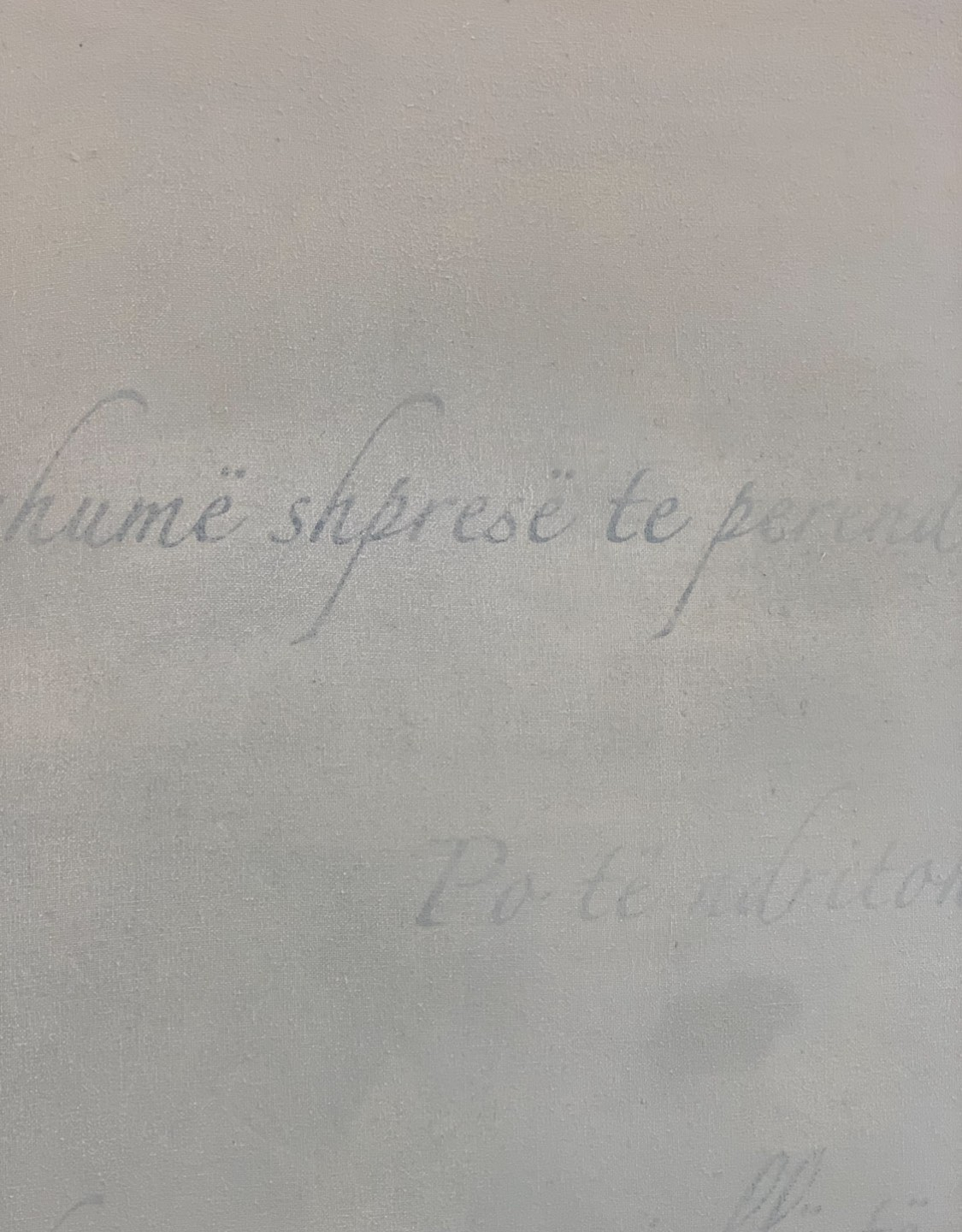 Close-up shot of painting depicting faded writing.