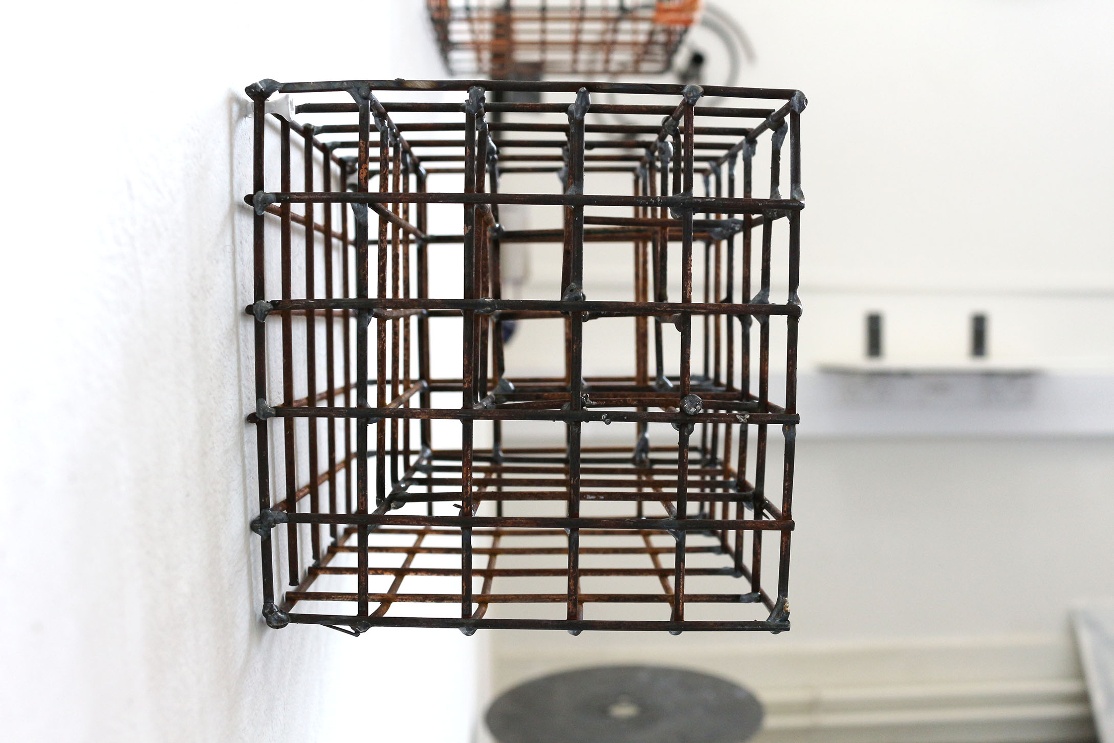 A cube made out of metal mesh, with more cubes inside it