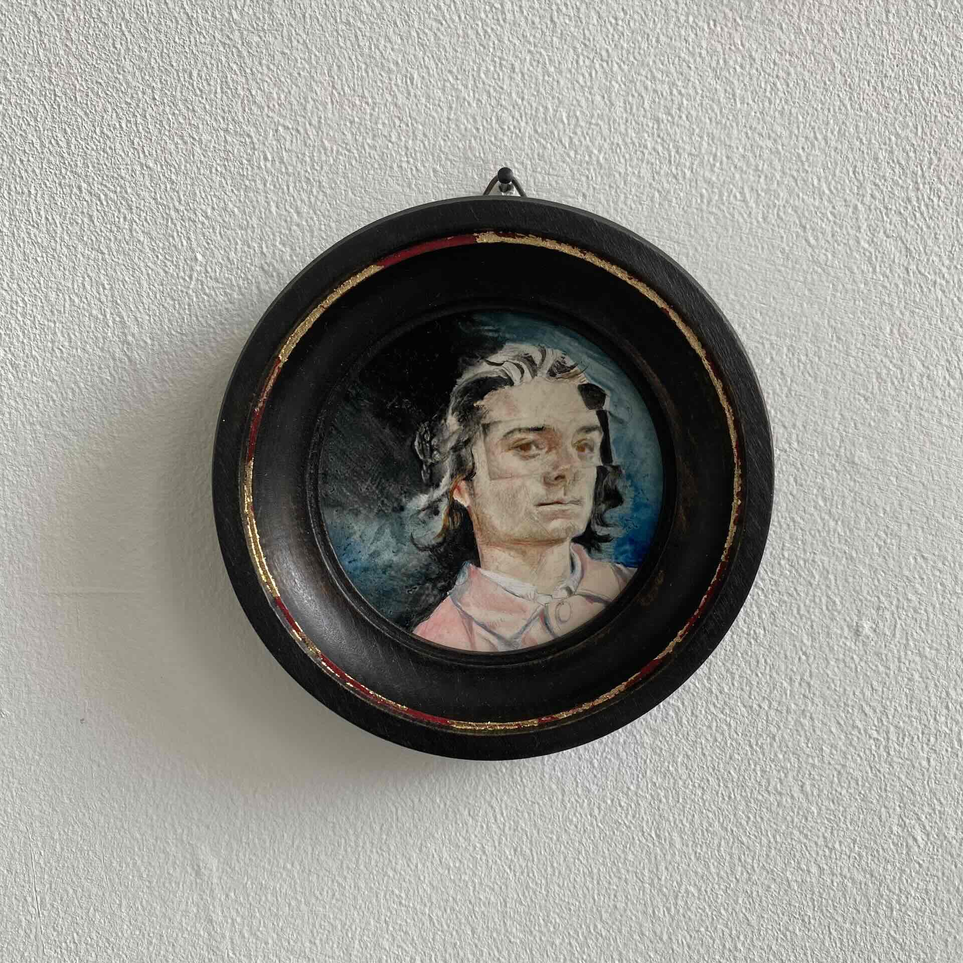 framed miniature portrait of a young man wearing a pink coat