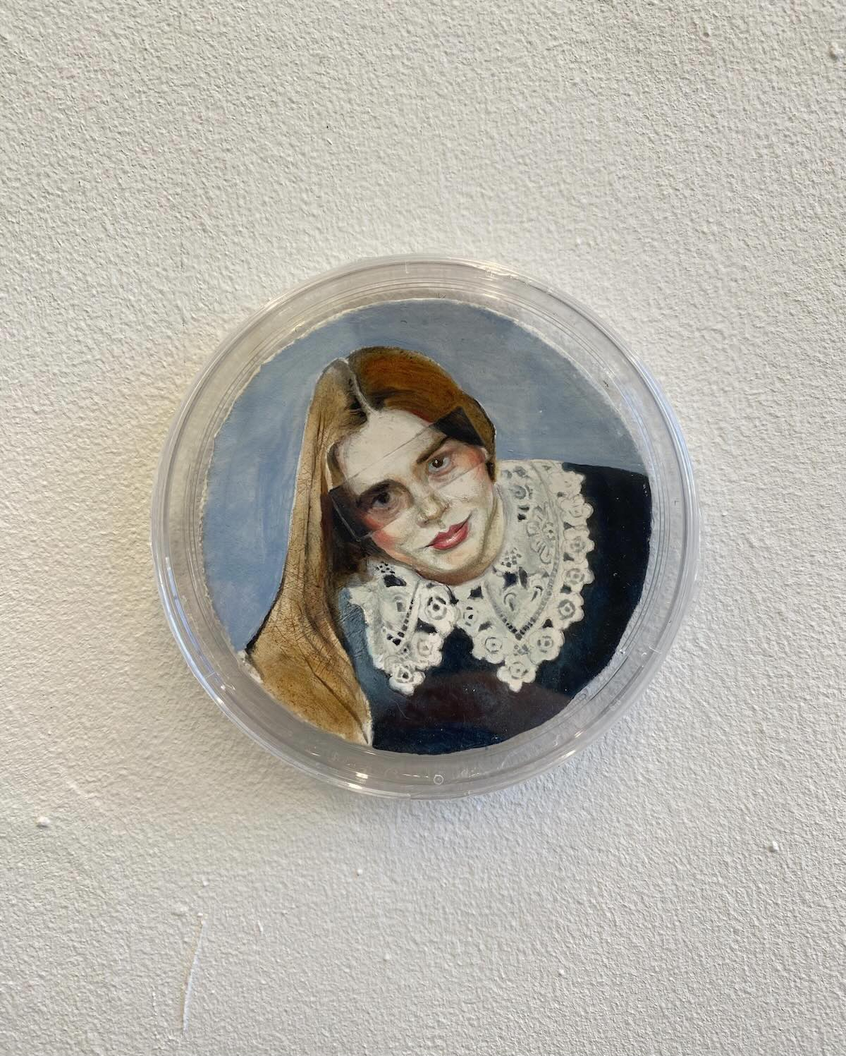 round miniature showing a young woman in a lace collar