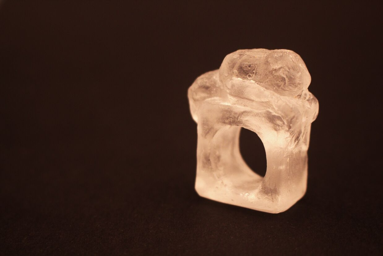 glass ring of a woman laying down. 