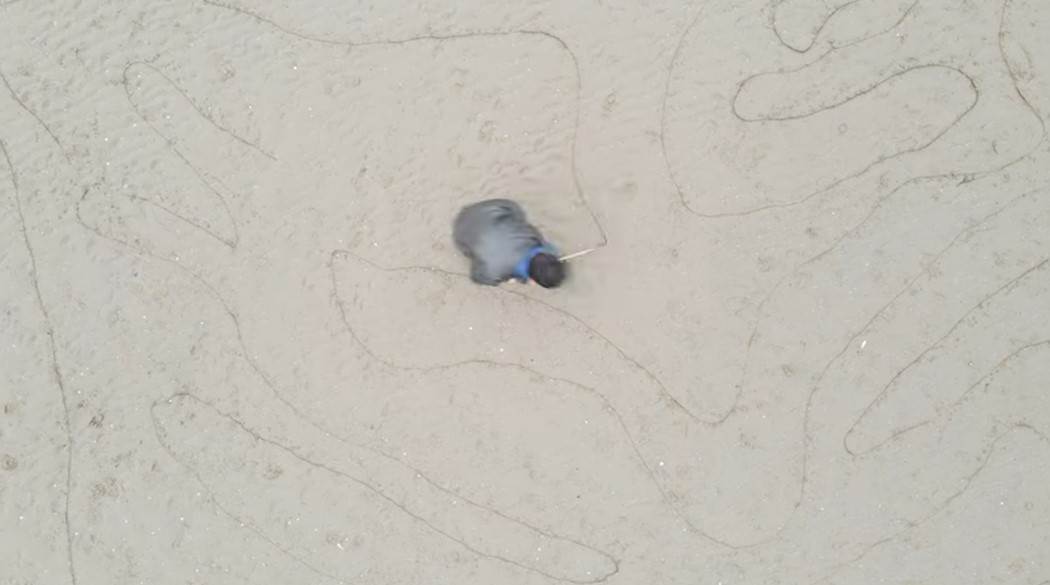 Stills from Geoglyph Series, video performance/drawing, etching in sand, 8m x 10m