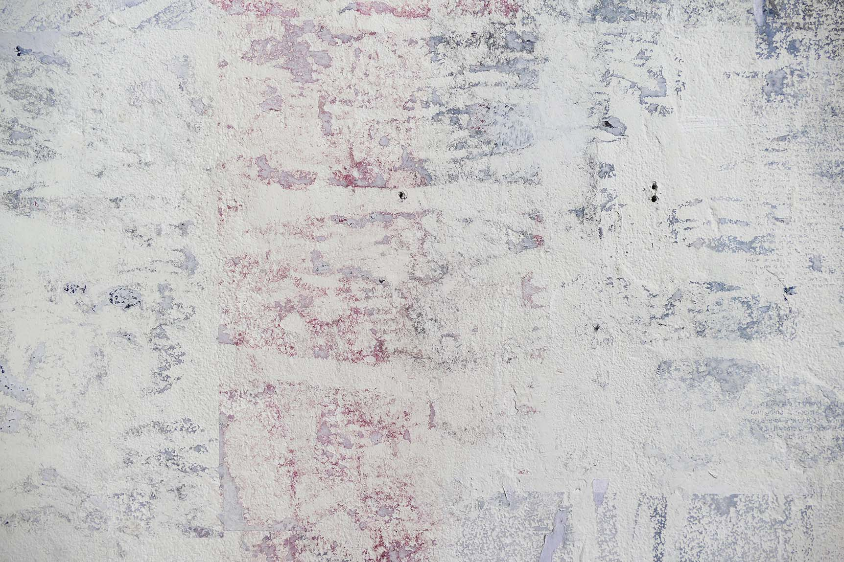 detail of a mural with a grainy texture and a reddish hue - resembling torn down posters 