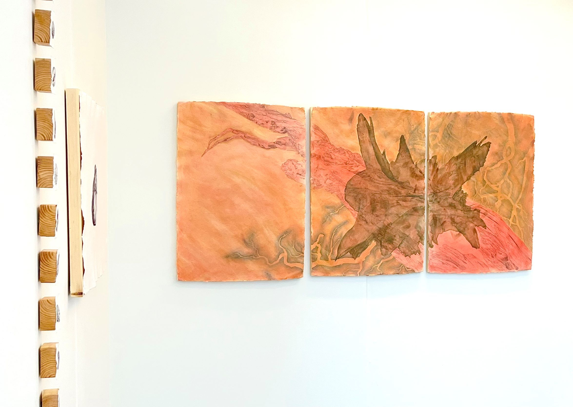 Gallery veiw of multiple paintings in a white cube space.