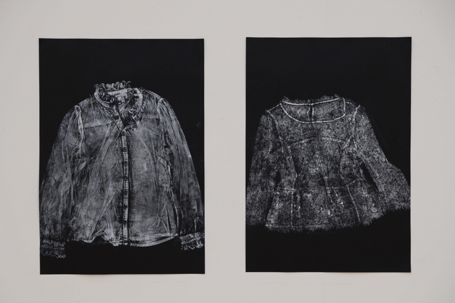 Prints of cardigan using white printing ink on black card.