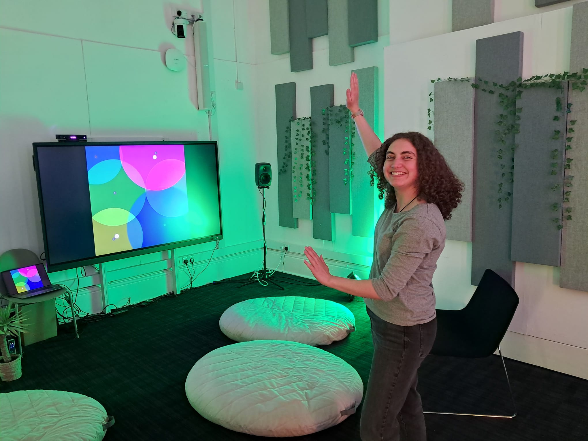 A person moving their hands to interact with the sound installation