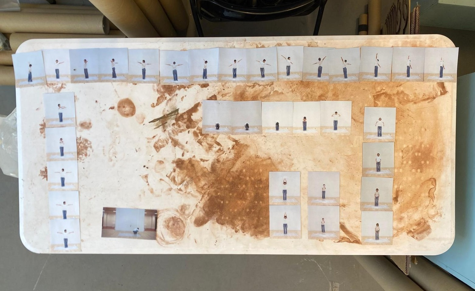 Printed pictures of the movement experimentation with rice flour, arranged on the studio desk