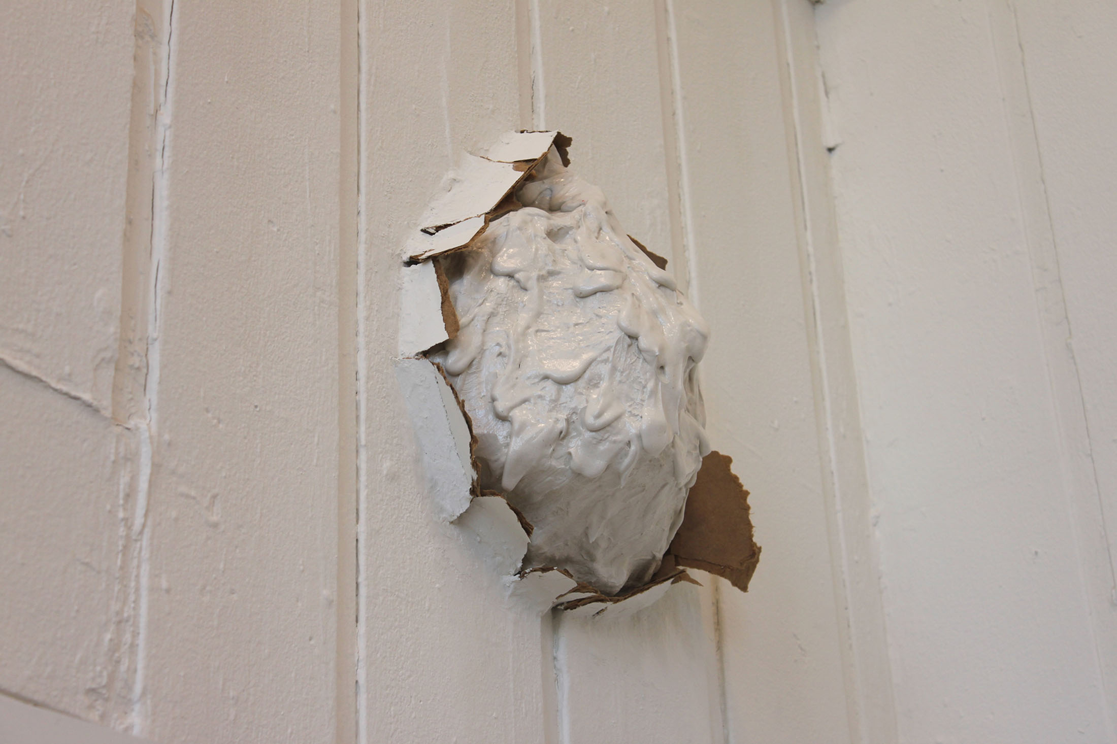 Small dripping Polyfilla sculpture bursts from the wall