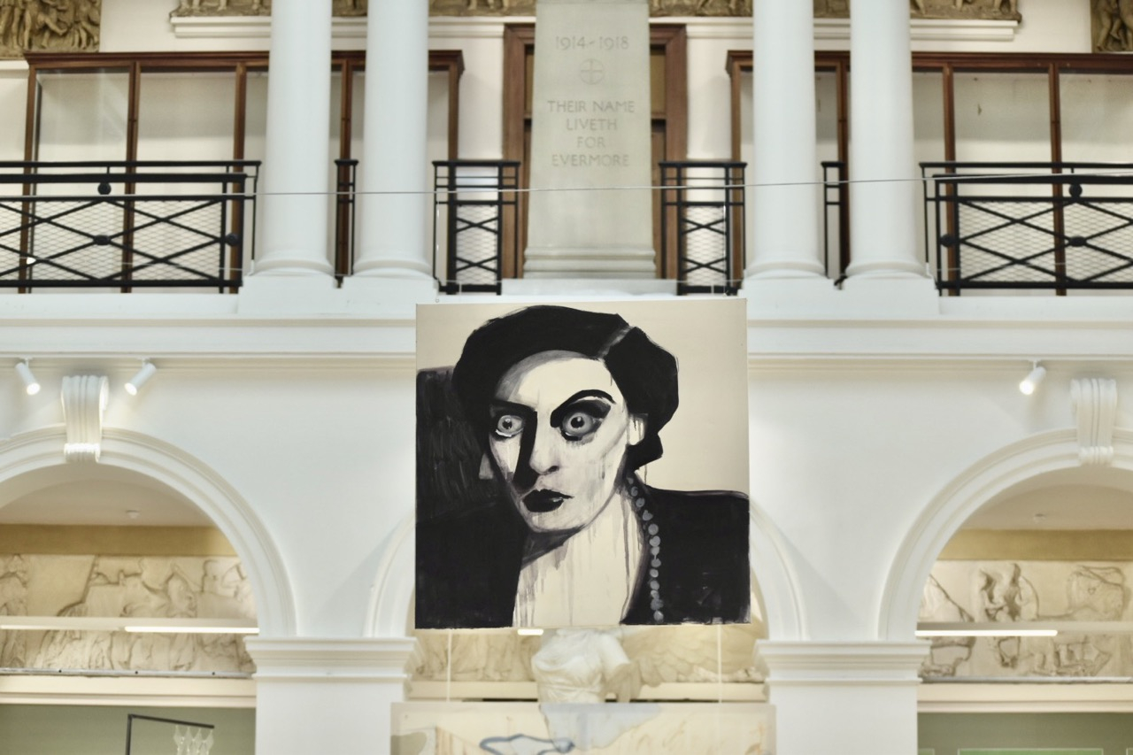 painting of Joan Crawford suspended on a wire with interesting architecture in the background