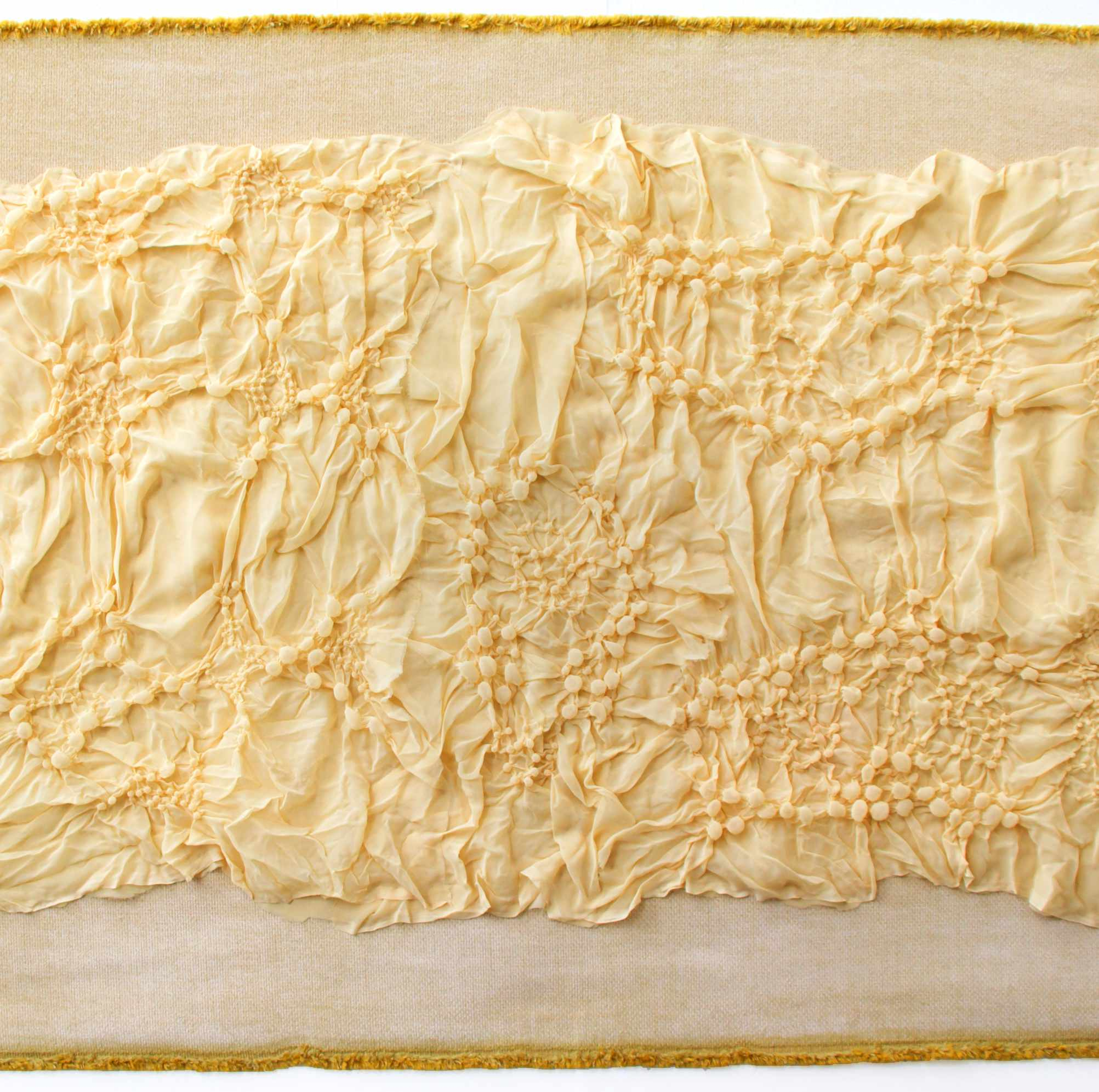Detail from a larger relief style yellow work, with a bubbled yellow polyester fabric 