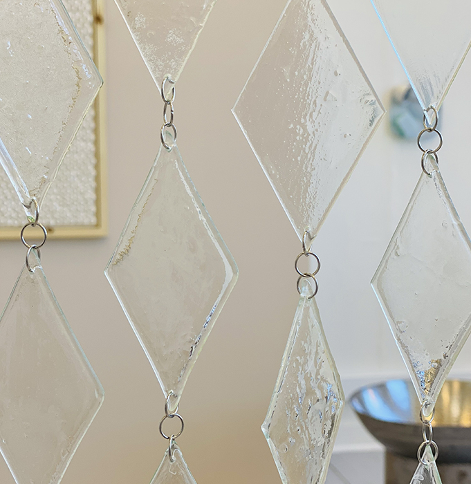 Diamond shaped glass pieces tied by rings